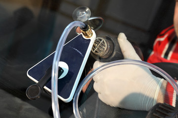 Mechanic repair damaged windshield with equipment