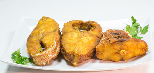 Portions of deep fried red snapper fish.