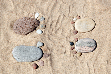 stone feet on the sand
