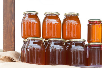 Glass jars with honey on a table isolated