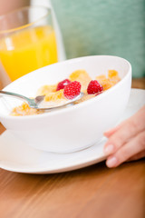 Close up of plate with cereals and strawberry 