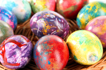 Fototapeta na wymiar Beautiful Easter eggs in wicker basket close-up