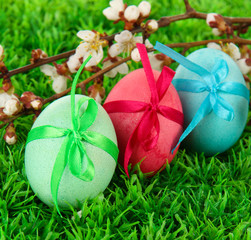 Colorful eastern eggs on  grass background