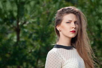 Naklejka premium Portrait of beautiful young girl outdoors in spring
