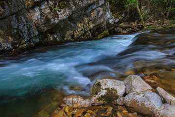 Waterfalls and mountain stream in the forest in spring