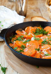 carrots in a frying pan with herbs