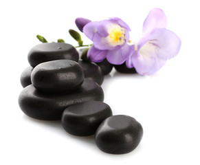 Obraz na płótnie Canvas Spa stones and purple flower, isolated on white