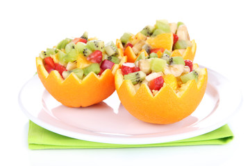 Fototapeta na wymiar Fruit salad in hollowed-out orange isolated on white