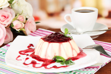 Panna Cotta with raspberry sauce, on bright background