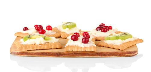 Tasty canapes with cheese, kiwi and cranberry,