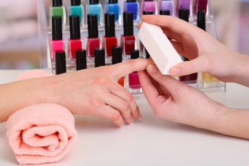 Manicure process in beauty salon, close up