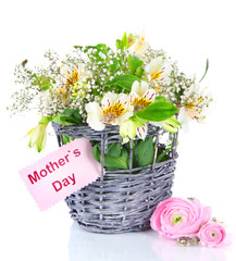 Bouquet of flowers in basket isolated on white