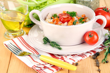 Delicious rice with vegetables and herbs in pot