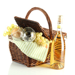 Picnic basket with grape and bottle of wine, isolated on white