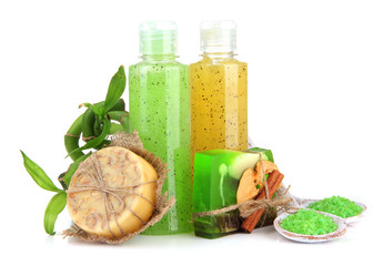 Bottles with scrub and hand-made soap, isolated on white