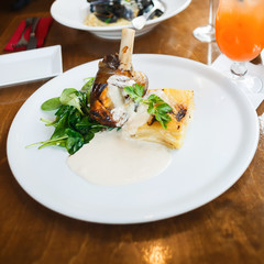 Lamb knuckle on rosemary with leave spinach