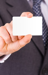 Business man showing blank card.