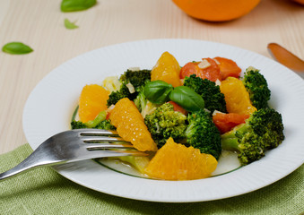 Delicious broccoli salad with tomato, garlic and orange