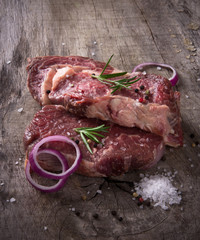 Raw beef steaks on wooden table