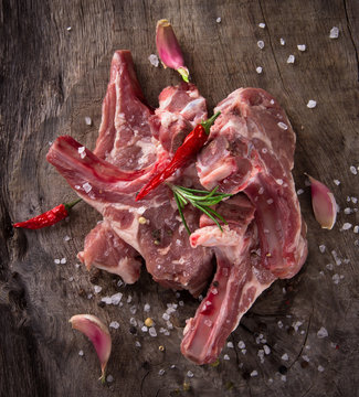 Raw lamb chops on wooden table