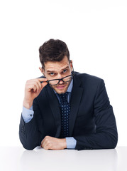 Young businessman holding black glasses