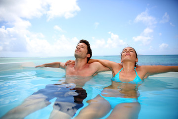 Fototapeta premium Couple relaxing in swimming pool