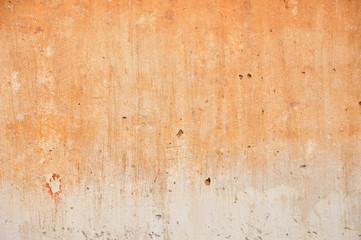 Red clay stained on the white exposed crack concrete wall.