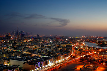 Fototapeta na wymiar A skyline panorama of Dubai at dusk showing Deira and the Creek