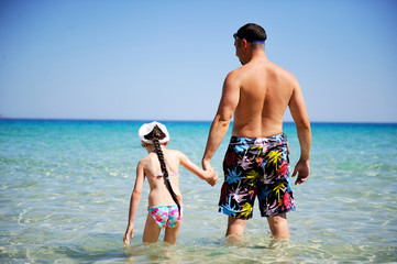 Happy father and his daughter ready to swim