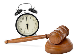 Judge gavel and soundboard over clock isolated on white