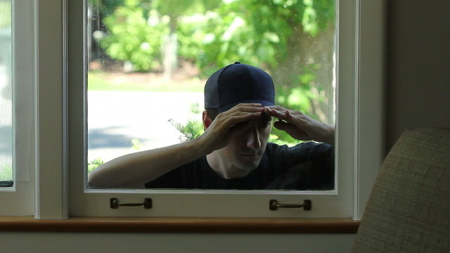 Intruder trying to enter window of home