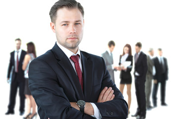 Fototapeta premium Handsome happy businessman with colleagues at the back