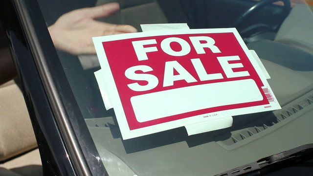 For sale sign put in car window
