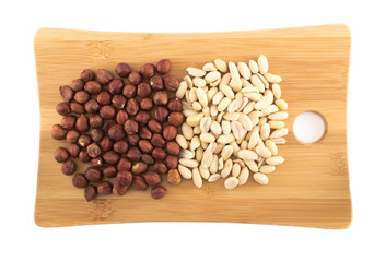 Wooden cutting board covered with nuts