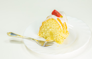 A slice of cheese pound cake coated with sugar glaze