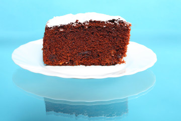 chocolate cake with icing sugar on blue