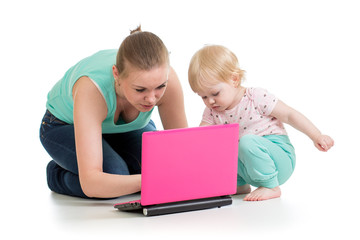 mother and child working at laptop