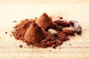 Chocolate truffles and cocoa, on wooden background