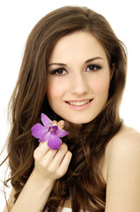 Beautiful girl holding orchid flower in her hands