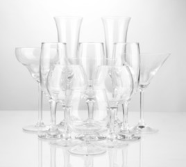 Cocktail and wine glasses, on gray background