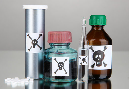 Deadly poison in bottles on grey background