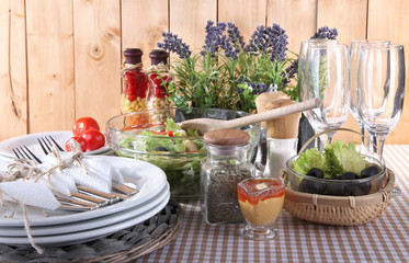 Table setting on checkered tablecloth on wooden background