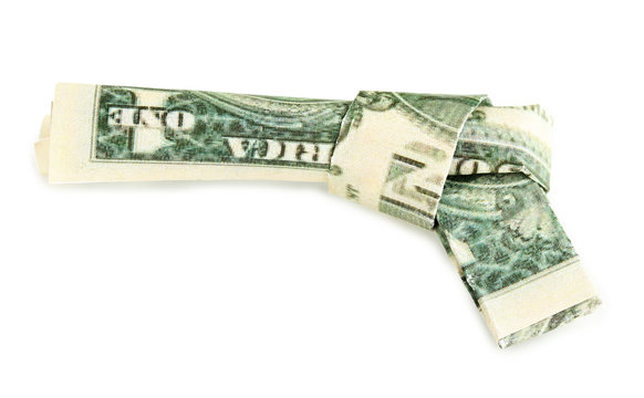 Dollar folded into gun isolated on white