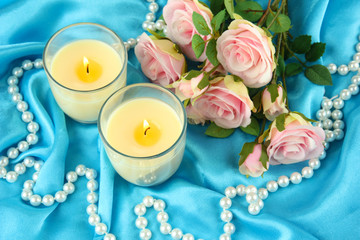 Obraz na płótnie Canvas Candles on blue fabric close-up
