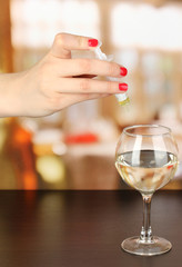 Pour something into glass with drink