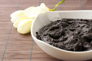 Cosmetic clay for spa treatments, on bamboo background