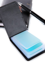 Black business card holder notebook and pen close-up