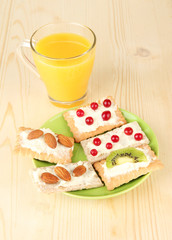 Tasty canapes with cheese, kiwi and cranberry, almond,
