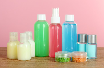 Hotel amenities kit on table on pink background