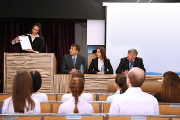 Business woman is making a speech at conference room